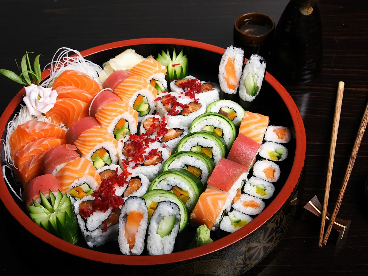 Large assorted sushi platter with fresh sashimi and maki rolls